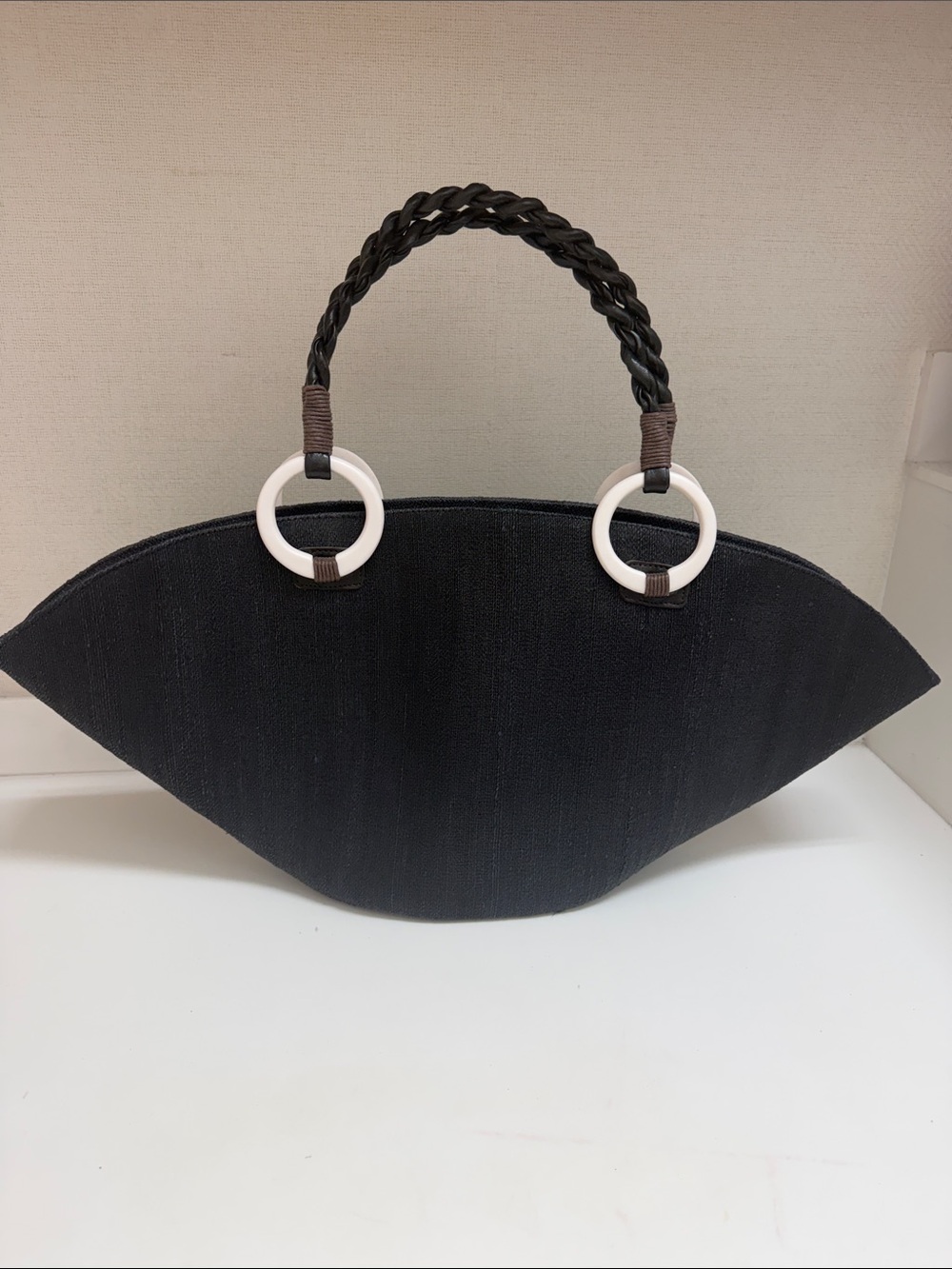 Sleek Black Tote with Braided Handle and White Ring Trim